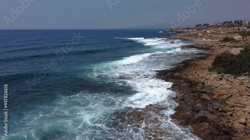 Aerial drone video of rocky beach in Paphos Cyprus island with waves Mediterranean Sea photo