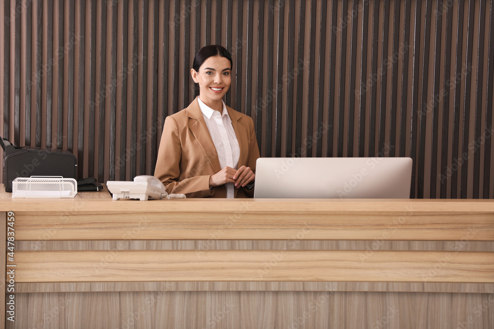 Portrait of receptionist at countertop in office Portrait of receptionist at countertop in office