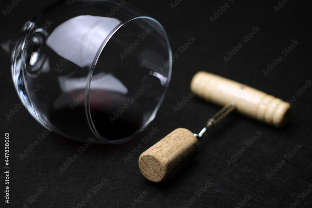 closeup detail of glass of red wine and pulls cork. Sale and distribution of wines. wine tasting