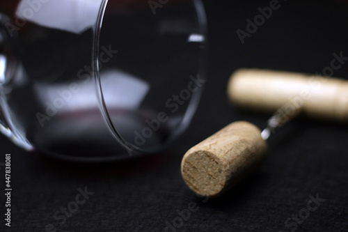 closeup detail of glass of red wine and pulls cork. Sale and distribution of wines. wine tasting