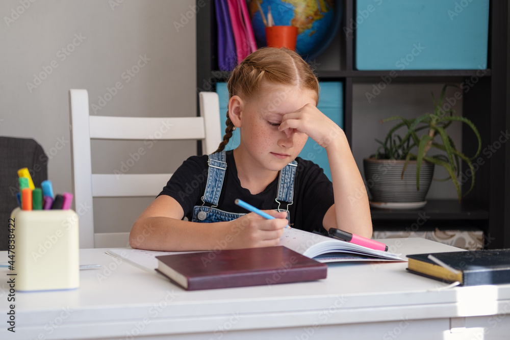 tired exhausted redhead girl doing homework. Back to school. tired exhausted redhead girl doing homework. Back to school.