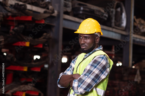 Portrait of Africa warehouse worker standing in large warehouse. 