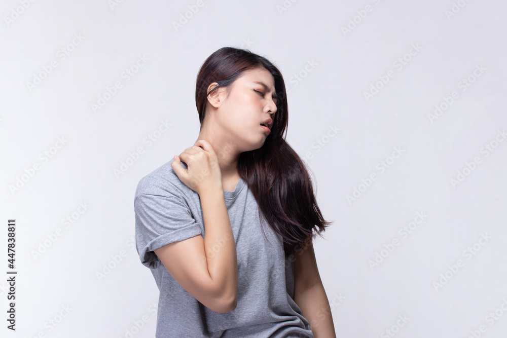 Beautiful young woman feeling face that expression pain holding neck and shoulder. Health care and medical concept. Beautiful young woman feeling face that expression pain holding neck and shoulder. Health care and medical concept.