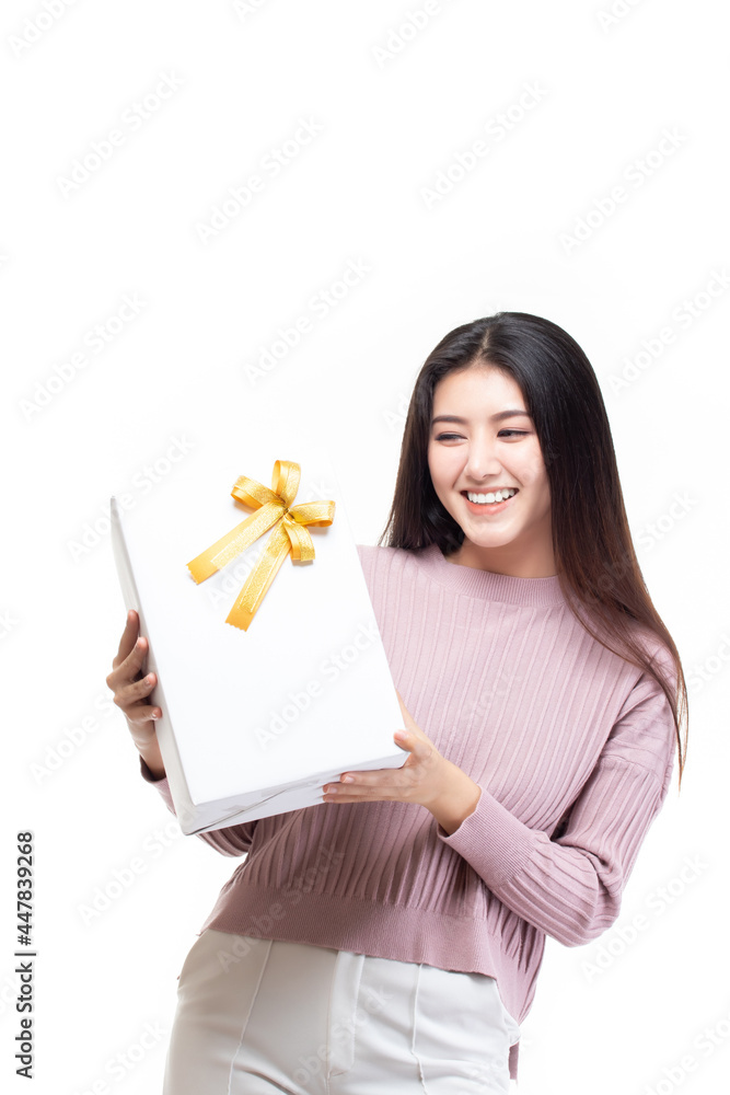 Attractive asian woman holding gift box in christmas, new year, valentine day, birthday celebration concept. Portrait of smiling happy pretty girl hold gift box isolated on white with copy space. Attractive asian woman holding gift box in christmas, new year, valentine day, birthday celebration concept. Portrait of smiling happy pretty girl hold gift box isolated on white with copy space.