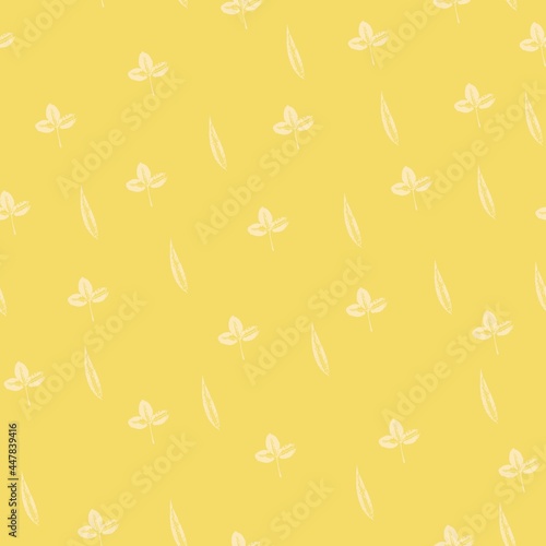 Seamless pattern with prints of leaves on a trendy yellow background. Grunge leaf print. Printing on fabric, wallpaper, packaging, stamp or leaf print
