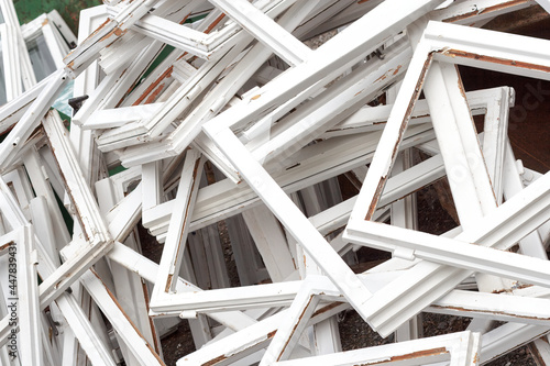 Construction and reconstruction concept, replacing windows. Heap of old wooden window frames