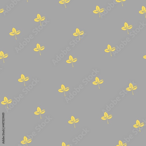 Seamless pattern with prints of yellow leaves on a trendy gray background. Grunge leaf print. Printing on fabric, wallpaper, packaging, stamp or leaf print