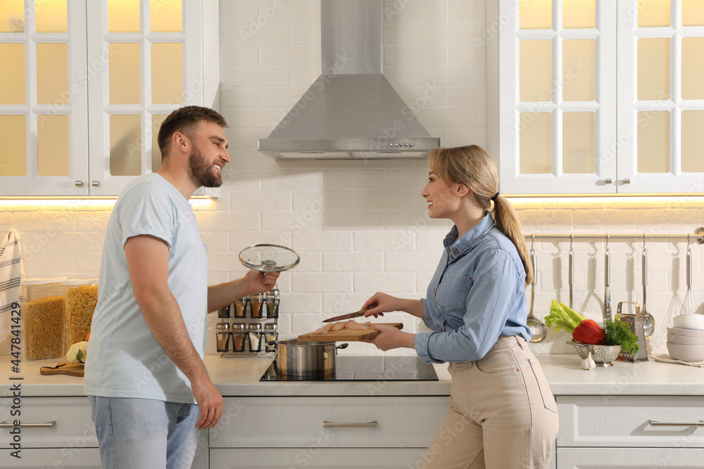 Fototapeta premium Young couple making delicious bouillon together in kitchen. Homemade recipe