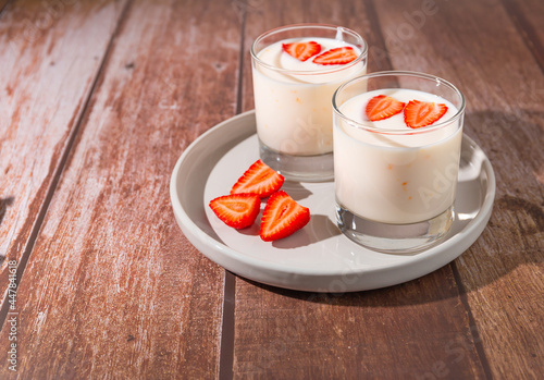 yogurts with strawberries on a plate