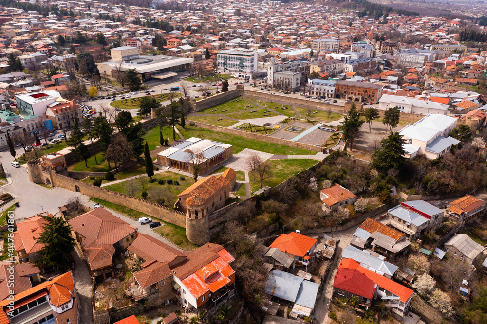 Panoramic aerial view of Telavi cityscape with residential districts and architectural complex of Batonis Tsikhe Castle in spring, Georgia