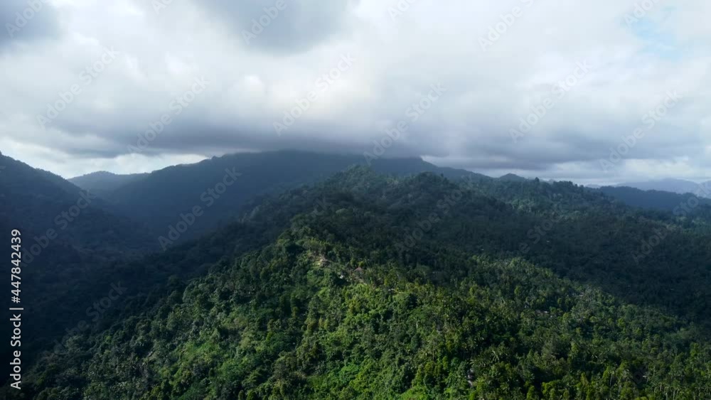 Drone flying near mountains and volcano covered by green trees in Bali Indonesia. High quality 4k aerial footage Drone flying near mountains and volcano covered by green trees in Bali Indonesia. High quality 4k aerial footage