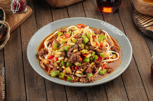 Asian uyghur dish suiru lagman noodles on a wooden background photo