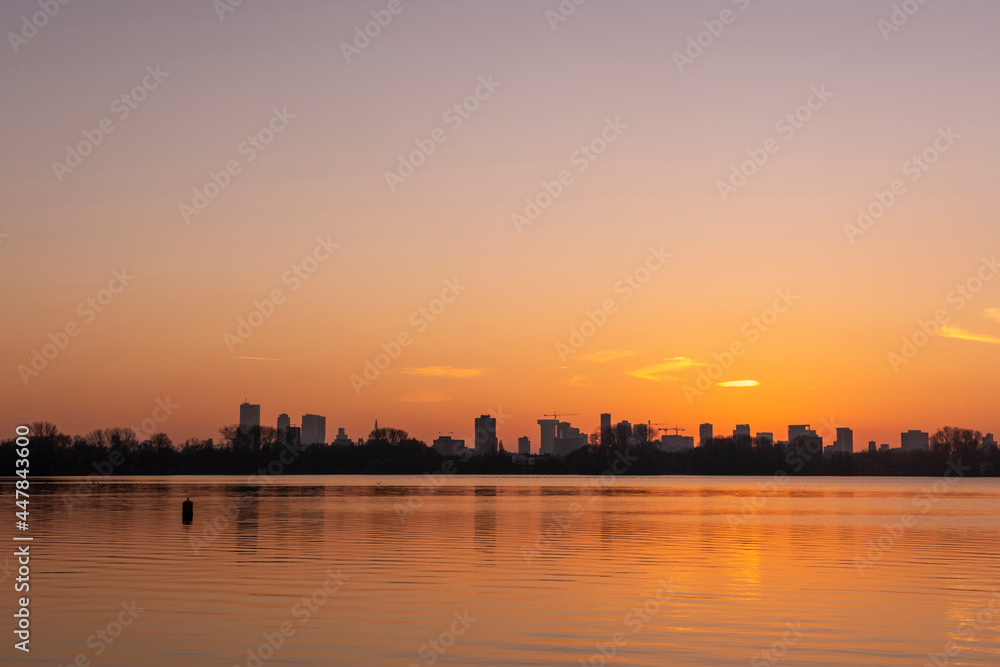 Sunset over the Rotterdam skyline as seen from Kralingse Plas (Lake Kralingen) with colorful sky reflecting Sunset over the Rotterdam skyline as seen from Kralingse Plas (Lake Kralingen) with colorful sky reflecting