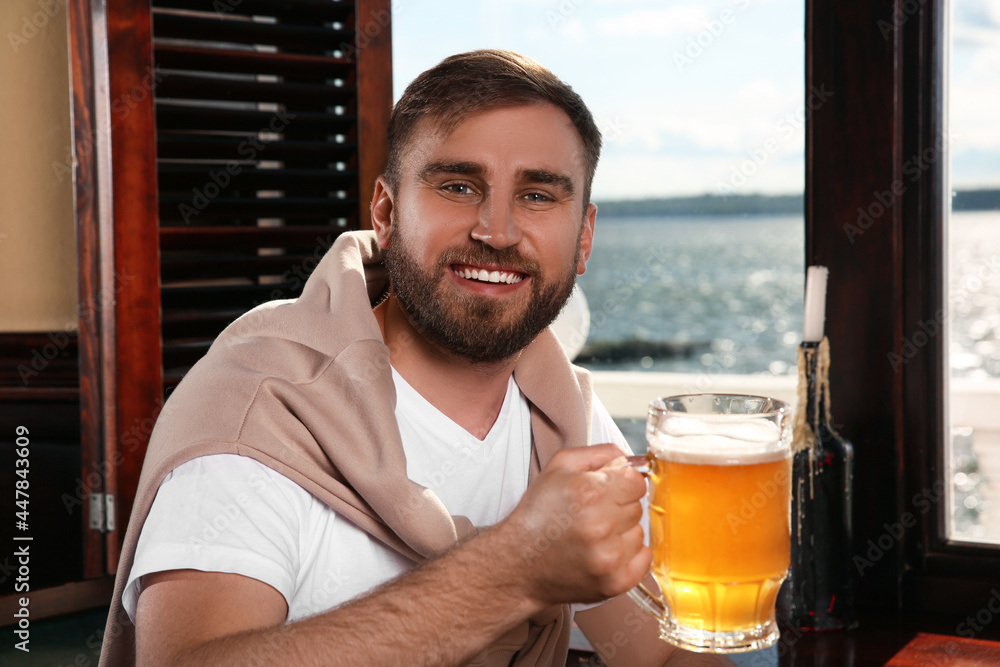 Man with glass of tasty beer in pub Man with glass of tasty beer in pub