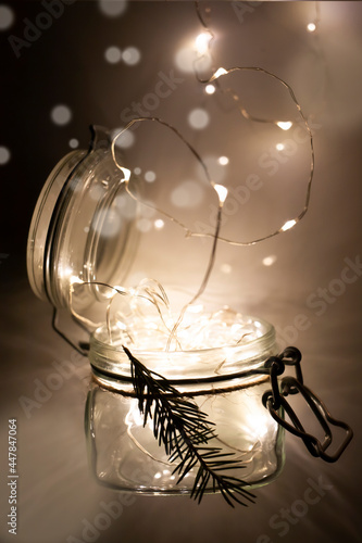 Glass jar with lights inside. The concept of New Year and Christmas. Vertical image.