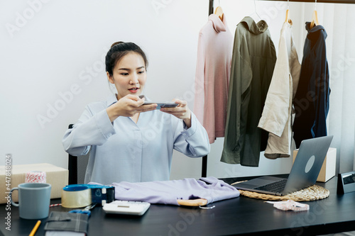 Asian entrepreneurs chatting with customers and taking pictures of their products sent to choose from a collection. photo