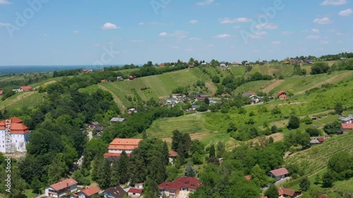 Townscape In Lush Vegetated Mountains In Lendava Town, Slovenia, Region Of Prekmurje. - Aerial Drone Shot photo