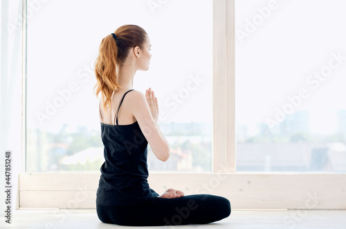 woman near window yoga meditation relaxation