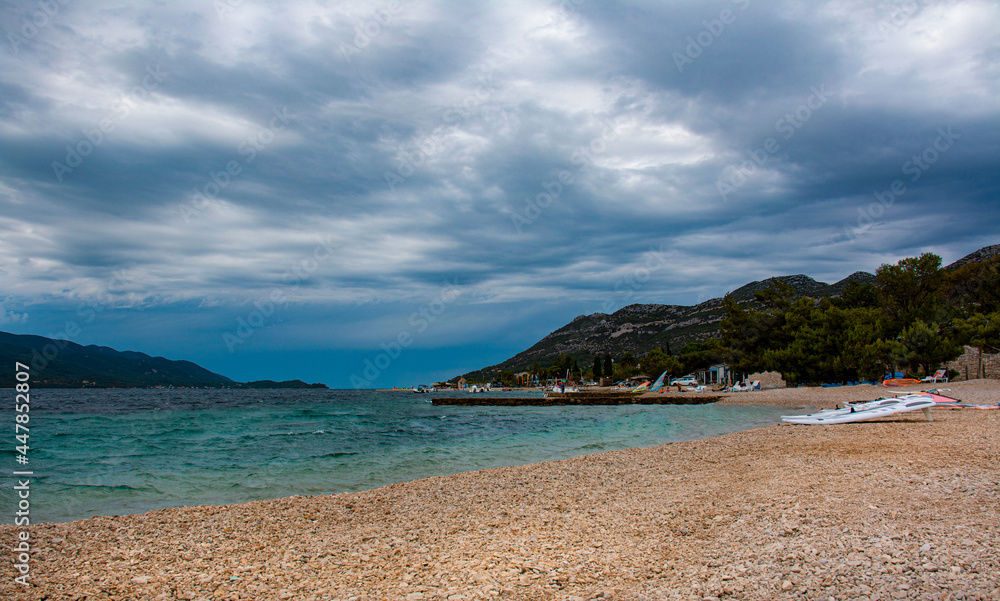 Dark stormy clouds gather above a popular windsurfing beach in Peljesac, Croatia