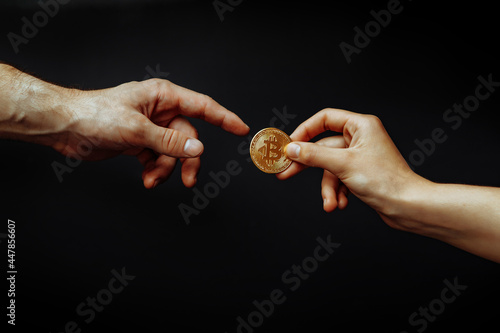 Bitcoin transfer concept from hand to hand.