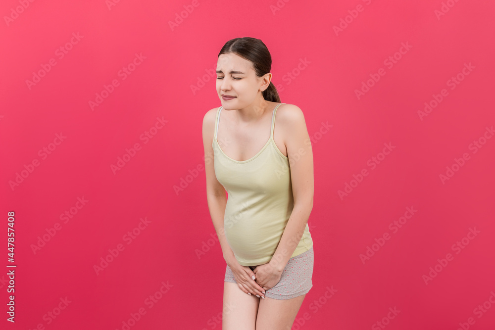urinary incontinence during pregnancy. Abdominal pain during pregnancy. Maternity healthcare concept on colored background urinary incontinence during pregnancy. Abdominal pain during pregnancy. Maternity healthcare concept on colored background