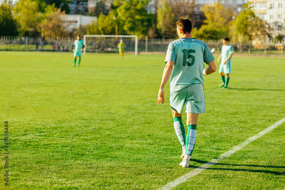 Professional soccer player, soccer player in action at the stadium, hitting the ball to reach the goal, Sport concept, competition Professional soccer player, soccer player in action at the stadium, hitting the ball to reach the goal, Sport concept, competition