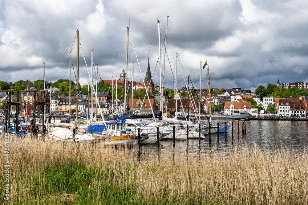 Sail boats in the port of Flensburg, St. Jorgen's Church in the background. Schleswig-Holstein in Germany