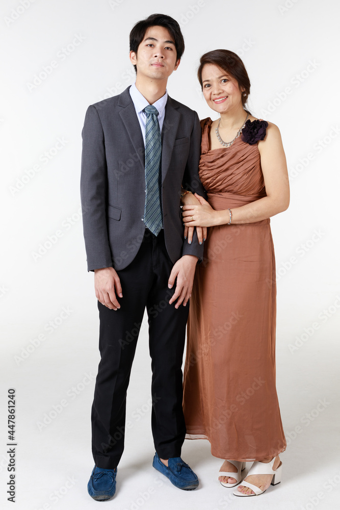 A warm family portrait in studio white background. Woman has become mother when she saw her handsome son grow up to be successful young businessman. Inevitably causes pride in her boy. A warm family portrait in studio white background. Woman has become mother when she saw her handsome son grow up to be successful young businessman. Inevitably causes pride in her boy.