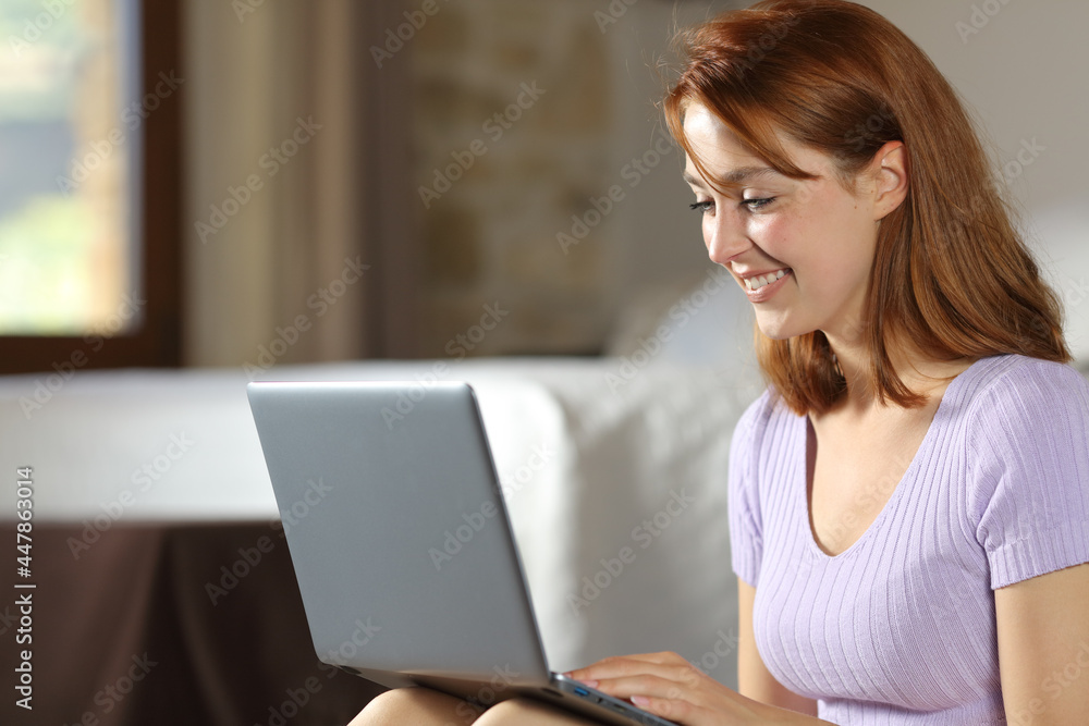 Happy woman using laptop in the bedroom at home Happy woman using laptop in the bedroom at home