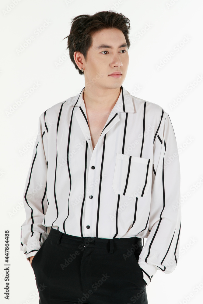 Portrait of self confidence young and handsome business Asian man with friendly and charming successful emotion pose against isolated on white background with hand in pocket Portrait of self confidence young and handsome business Asian man with friendly and charming successful emotion pose against isolated on white background with hand in pocket