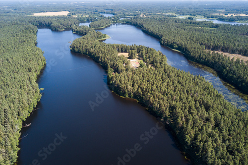 Aerial view of Mordanga lake with peninsula in sunny summer day, Latvia.