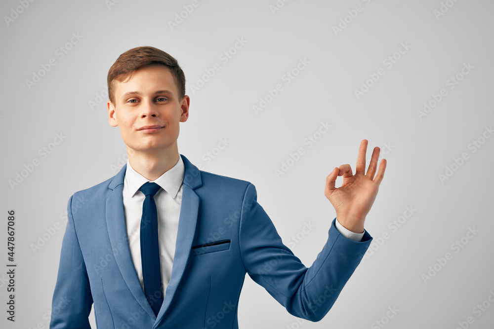 handsome business man in a suit and gesturing with his hands professional