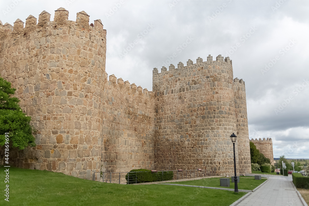 Detailed view of Ávila city Walls and fortress tower, blue sky as background