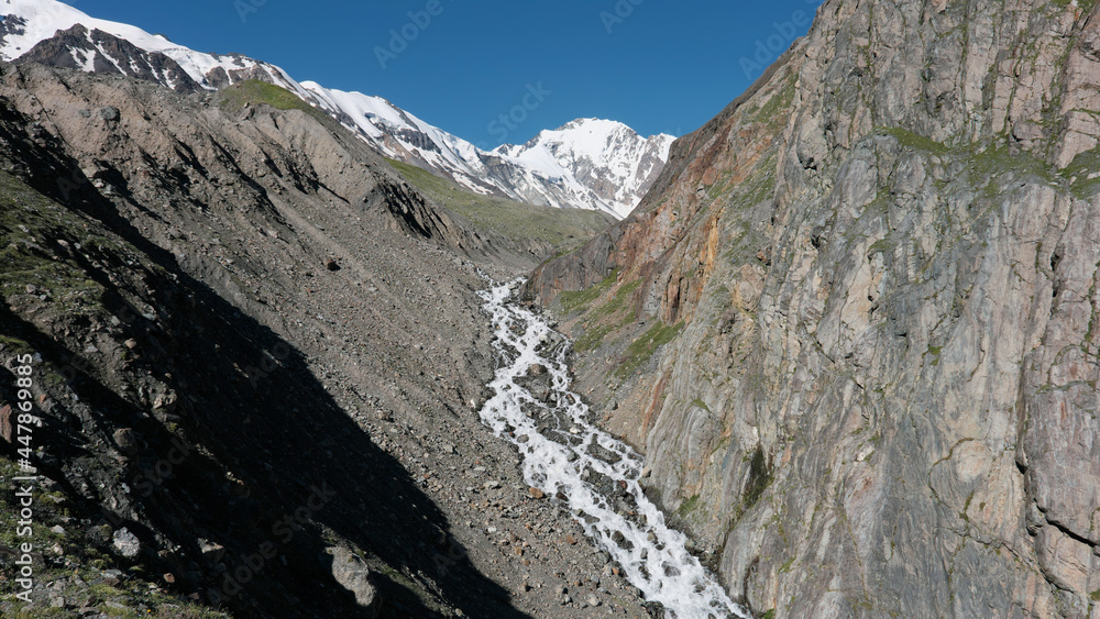 Caucasian landscape. View of upper part of Genaldon river on sunny summer day. North Ossetia–Alania, Russia. Caucasian landscape. View of upper part of Genaldon river on sunny summer day. North Ossetia–Alania, Russia.