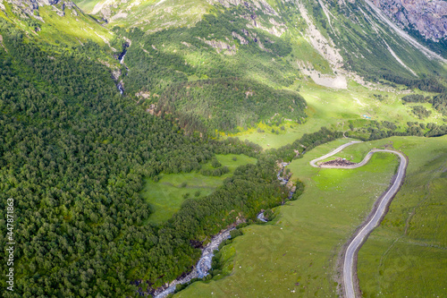 Aerial view of Balkarsky Cherek river gorge with sheep pen (sheepfold) on the roadside. Kabardino-Balkaria, Caucasus, Russia.