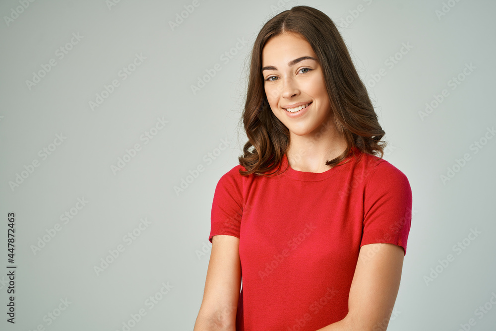 cheerful brunette holding her hair red t-shirt posing studio cheerful brunette holding her hair red t-shirt posing studio
