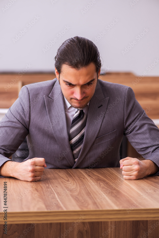 Fototapeta premium Young businessman employee sitting in the office