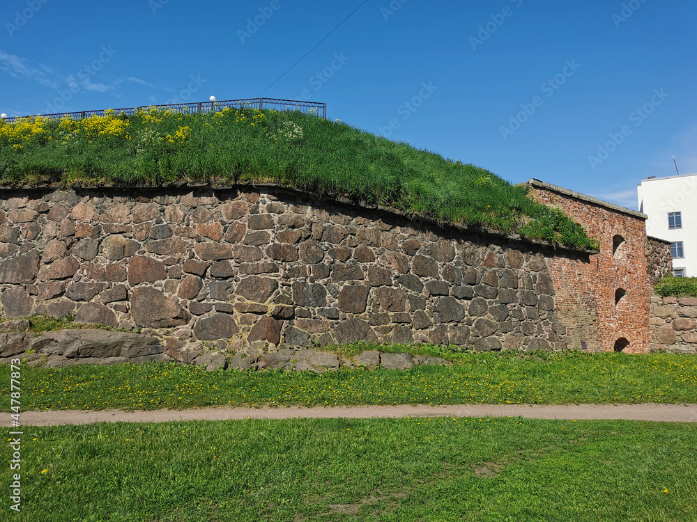 The wall of the Panzerlaks Bastion, built in the 16th century, in the city of Vyborg on a clear summer day.