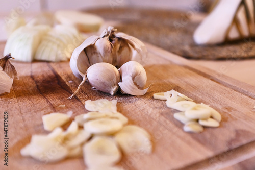 Garlics in a wooden cutting board waiting to be cooked 