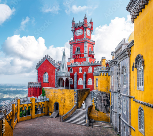 Traveler woman visiting Pena Palace in Sintra, Lisbon, Portugal. Famous landmark. The most beautiful castles in Europe photo