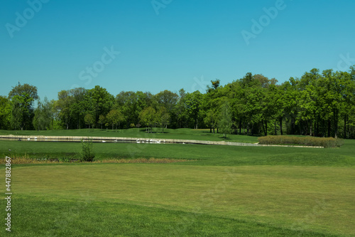Picturesque view of golf course with fresh green grass and trees
