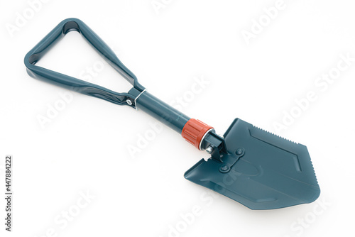 Folding camping shovel on the white background.