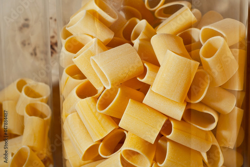 Pasta texture. Many yellow pasta are piled on the pile.