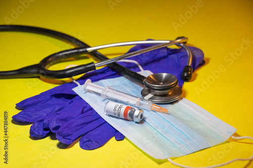 Coronavirus Covid-19 vaccine with syringe isolated on Yellow background