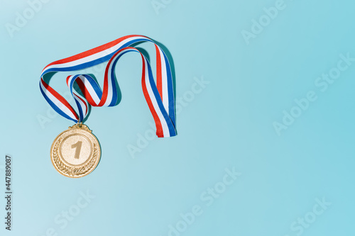 gold medal on blue background.award and victory concept.copy space