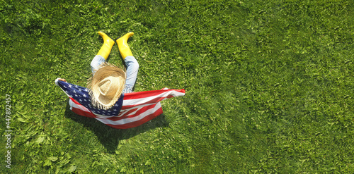 Man with the usa flag on lawn background. Top view. Holiday concept. © arsenypopel