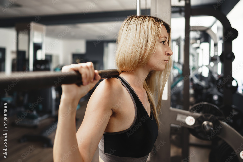 Fitness woman in sport outfit exercising in gym Fitness woman in sport outfit exercising in gym