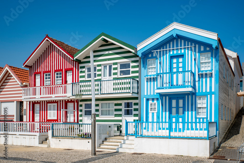 Street with colorful striped houses typical of Costa Nova, Aveiro, Portugal.