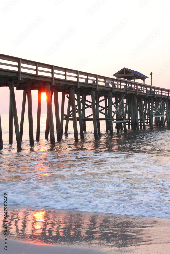 Beach, ocean, and pier at sunset