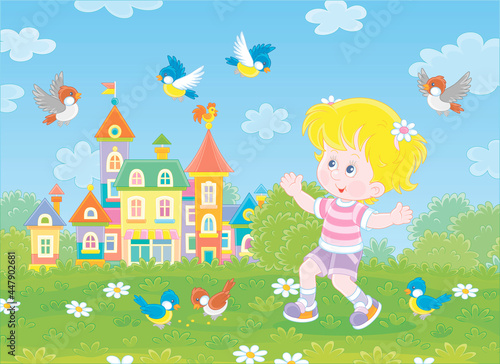 Happy little girl playing with a flock of merry sparrows and titmice in a green summer park of a pretty small town with colorful houses, vector cartoon illustration